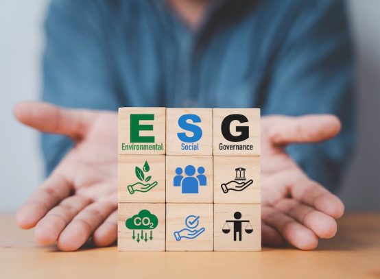 businessman-hand-give-esg-wording-wooden-cube-block-sustainable-organization-development-corporation-environment-social-governance-concept